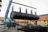 Crane installing a set of Maltin® System tanks in the lagoon at Organic Power's headquarters
